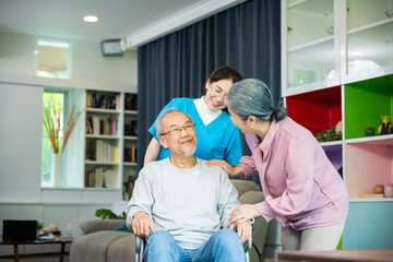 Asian old man on wheelchair with couple and nurse relaxing walking at home, healthcare medical...