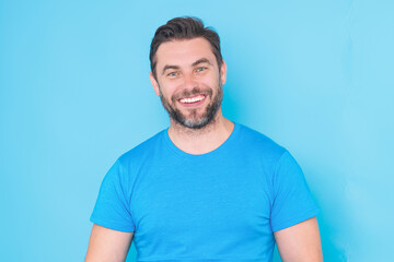 Obraz premium Studio portrait of Smiling male model isolated on yellow. Positive man in good mood. Friendly and happy. Handsome guy looking at the camera. Positive person.