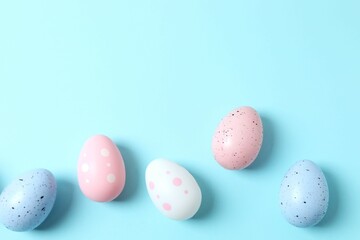 Happy Easter. Colorful eggs on a pastel blue background, space for text or advertising