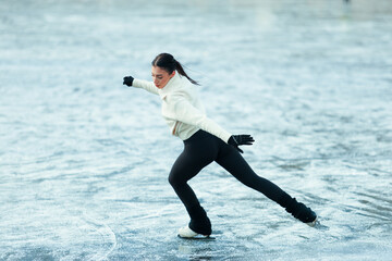 Figure skater girl on winter lake.
