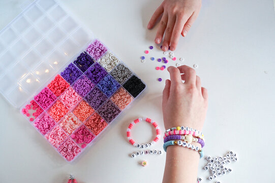 Diy jewellery making, friendship bracelets and hands close up.
