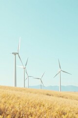 Serene landscape featuring wind turbines gracefully turning in a golden field under a clear sky