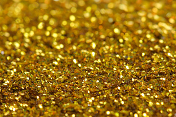 Glitter golden background. Shiny gold texture for party invitation, packaging, Christmas, New Year...