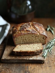 Rustic loaf of bread resting on a wooden board in a cozy kitchen setting