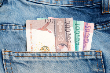 Aruban florin in the pocket of blue jeans