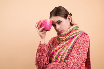 Sick woman drink medicine from mug. Woman holding a mug with hot drink for flu symptoms. Ill woman...