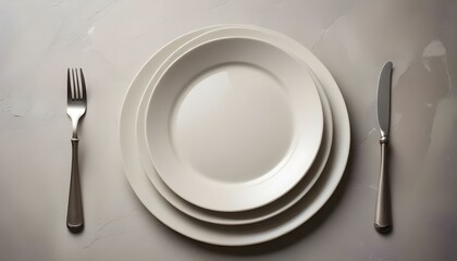 Table setting. plate, knife and fork on stone background