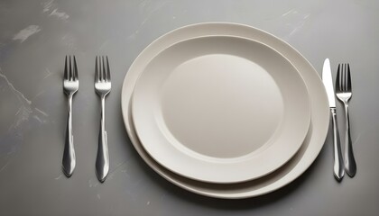 Table setting. plate, knife and fork on stone background