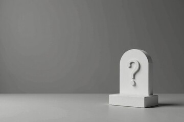 A White Question Mark on a Small Pedestal Against a Gray Background