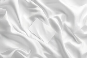 Obraz premium Blank Business Card on Soft White Satin Background Texture