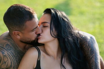 Fototapeta premium Close up face of a beautiful young couple in love embracing, romance and and affection. Sensual couple kiss. I love you. Romantic and love. Couple kissing, close up. Sensual kiss.