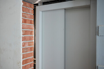 Fototapeta premium Contemporary interior column design featuring a sophisticated blend of gray and brick elements