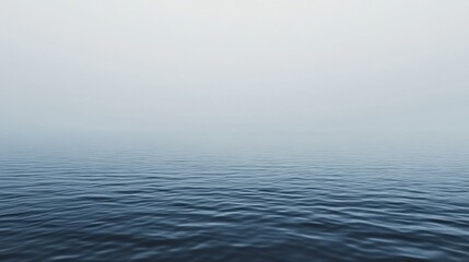 Obraz premium Monochromatic gradient of muted gray reflecting calm waters under soft, cloudy sky at dawn over serene landscape