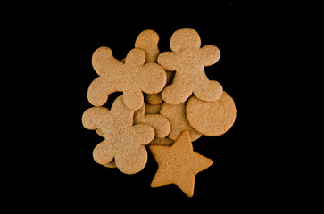 Thin gingerbread cookies on a black background