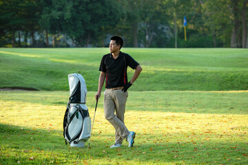 Obraz premium Golfer sport course golf ball fairway.Â&nbsp; People lifestyle man approach playing game golf tee off on the green grass.&nbsp; Asian man player game shot in summer.&nbsp; Healthy and Sport outdoor