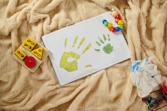 Children's Creativity Displayed Through Handprint Artwork on Soft Background