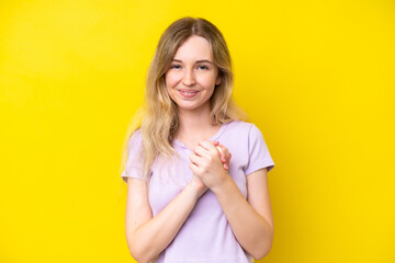 Obraz premium Blonde English young girl isolated on yellow background laughing