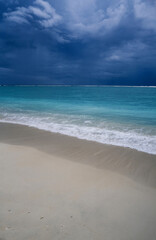 Fototapeta premium Tropical beach of Indian Ocean, dramatic sky over turquoise lagoon. Storm approach. Beautiful seascape. Mauritius island.