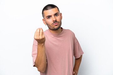Young caucasian man isolated on white background making Italian gesture