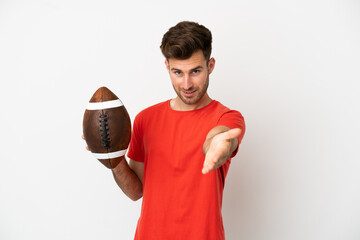 Young caucasian man playing rugby isolated on white background shaking hands for closing a good deal
