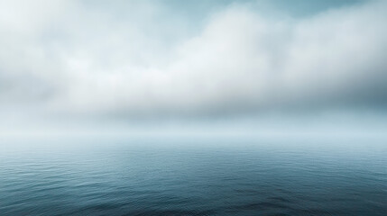 Fototapeta premium A majestic rolling fog over a calm ocean, dense mist drifting over the still water, soft diffused light casting a dreamy atmosphere