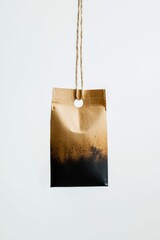 Burnt Paper Bag Hanging on Twine Against White Background