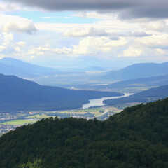 Fototapeta premium Scenic view of mountain, valley, river, forest, and sky that show beautiful nature and calm emotional expression of scenic view from top of mountain