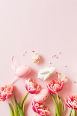 Pink tulips and Easter eggs on a pink background