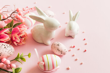 Pink tulips and Easter eggs on a pink background