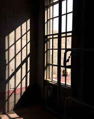 Shadows of through iron bars into the Confinement wall