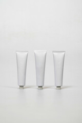 three white tubes on a white table