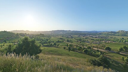 Naklejka premium Panoramic rural landscape, sunrise over rolling hills, small town nestled in valley. Possible use nature, travel, games