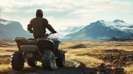 Young adult male on atv exploring scenic mountain terrain under cloudy sky