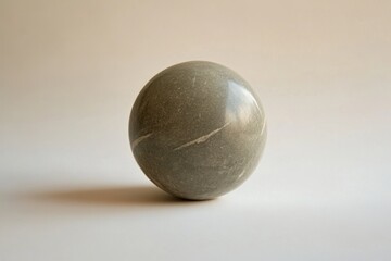 Polished stone sphere with a diagonal vein sits peacefully