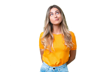 Young Uruguayan woman over isolated background and looking up