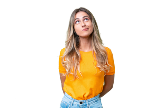 Young Uruguayan woman over isolated background and looking up