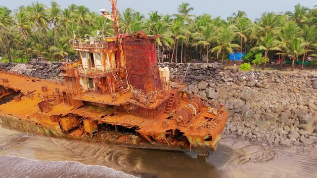 Drone shot forsaken vessel lies in shallow waters