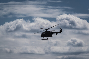 HELICOPTER - Multi-purpose machine in in flight against the blue sky
