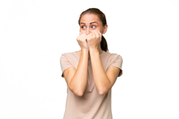 Young caucasian woman over isolated background nervous and scared putting hands to mouth