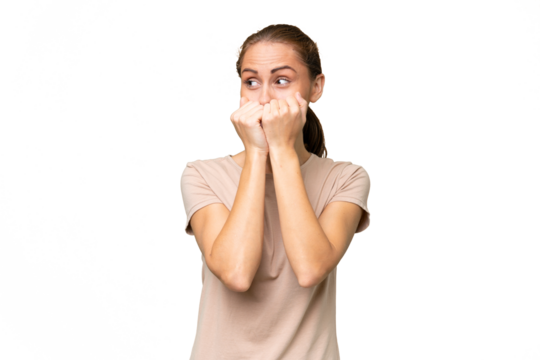 Young caucasian woman over isolated background nervous and scared putting hands to mouth