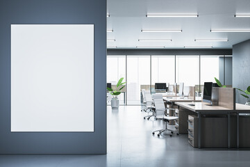 Modern office interior with blank vertical poster on dark wall. 3D Rendering