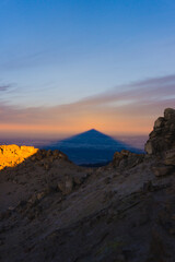 Obraz premium The longest shade on the planet Earth created by summit of Pico del Teide and first morning sunshine over the ocean on the top of the world, Tenerife, Gran Canaria, Spain