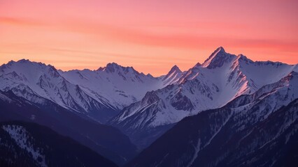 Soft pink sunrise lights the Rocky Mountains snowy peaks, alpine scenery, dawn break, mountain range