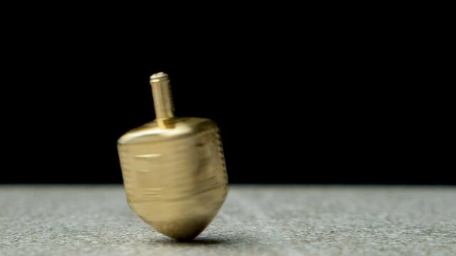 Traditional dreidel spinning fast slow motion. Spinning top Sevivon