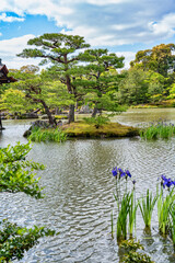 Beautiful scenic Japanese garden with a large pond on the grounds of Kinkaku-ji Temple located in Arashiyama, Kyoto.