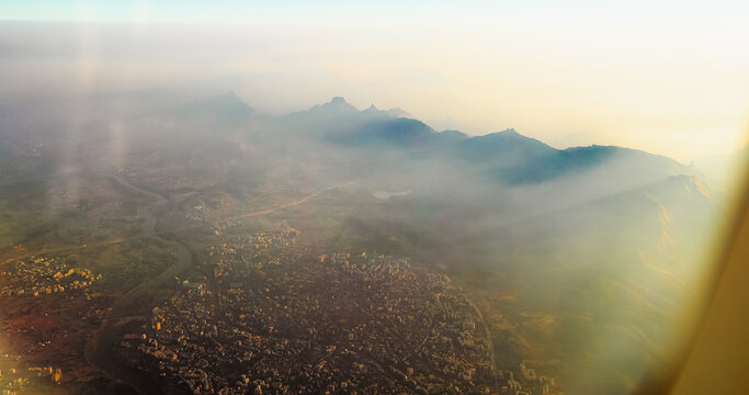 Ulhas river, Mumbai, India. Badlapur is a city in Thane district, Maharashtra state, India, and is a part of Mumbai Metropolitan Region. Aerial View From Airplane Window On View of the Mumbai suburb