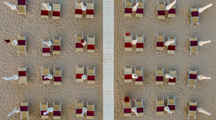 Top down view of closed umbrellas in the evening in summer at the beach of Marina di Ostuni, Puglia, Italy © Ponta shots