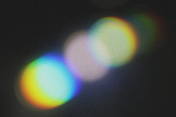 Blur colorful rainbow crystal light leaks on black background. Defocused abstract multicolored retro film lens flare bokeh analog photo overlay or screen filter effect.