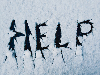 Snow with a written message saying Help