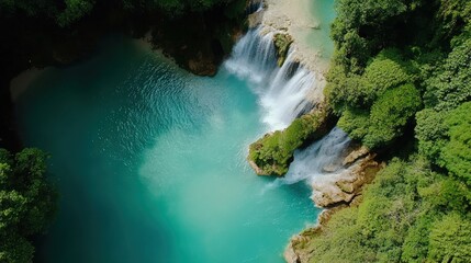 the famous Kuang Si Waterfalls in Laos, with crystal-clear turquoise waters flowing through lush green jungle, creating a breathtaking natural background